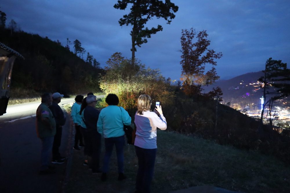 a group of people standing on top of a hill