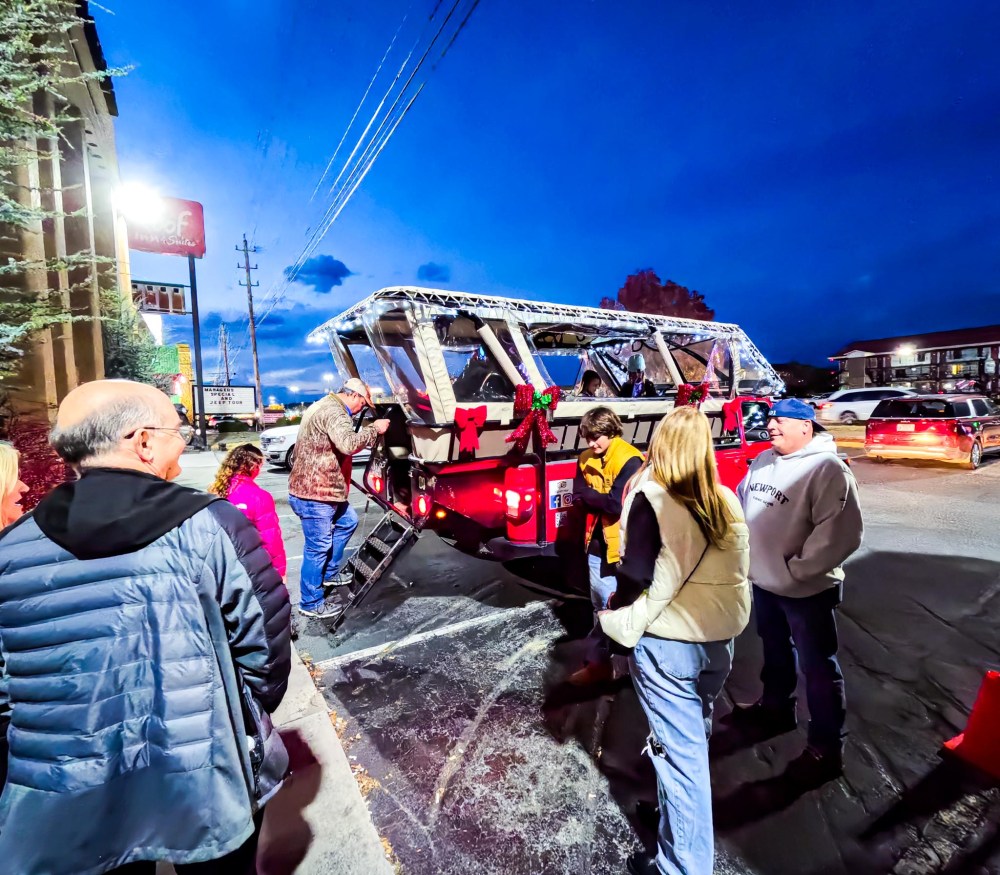 a group of people riding on the back of a truck