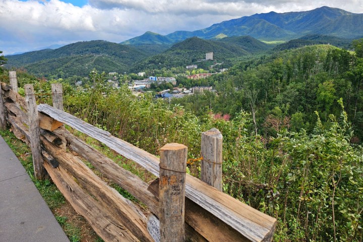 a wooden bench on the side of a mountain